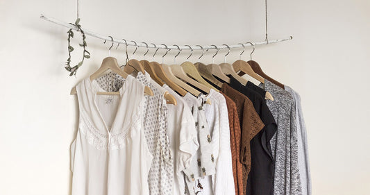 Second hand women's shirts hanging on a single rack promoting the Natural Fabrics collection at BinxBerryConsignment.com, a popular online thrift store